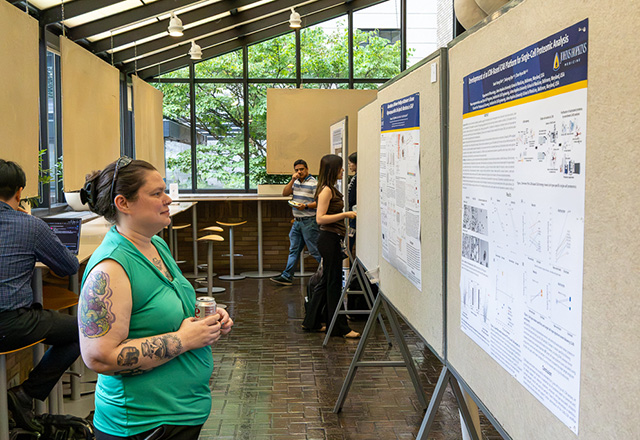 researcher looking at poster