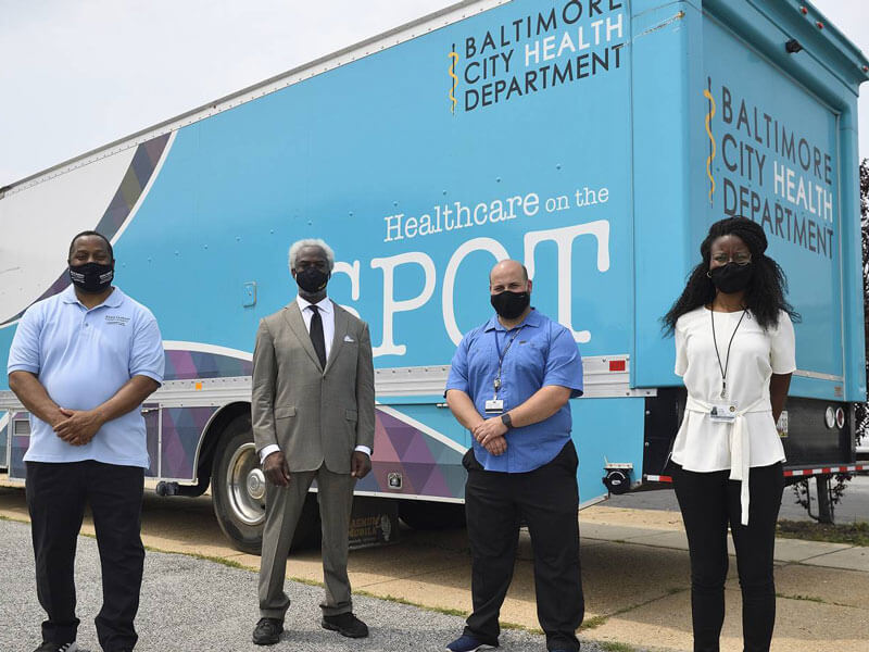 Volunteers in front of mobile clinic