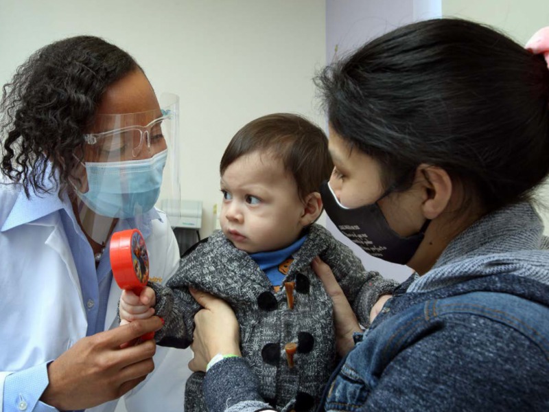 doctor provides check up to small child