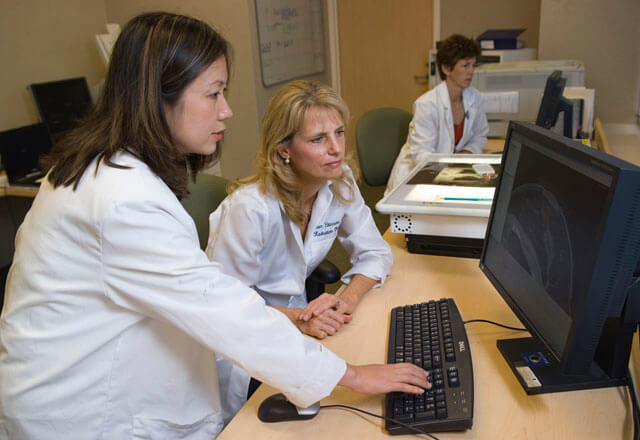 physicians viewing a computer monitor
