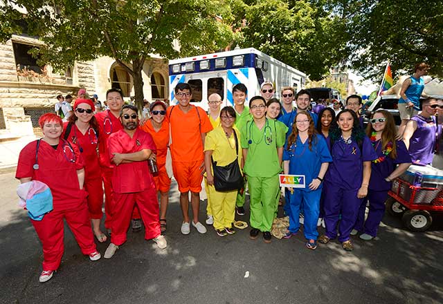 Healthcare workers wearing rainbow scrubs.