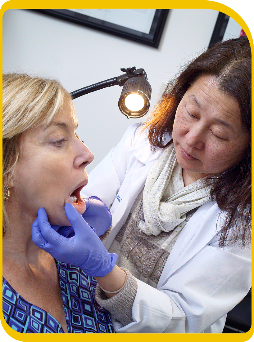 Doctor checking a woman's mouth