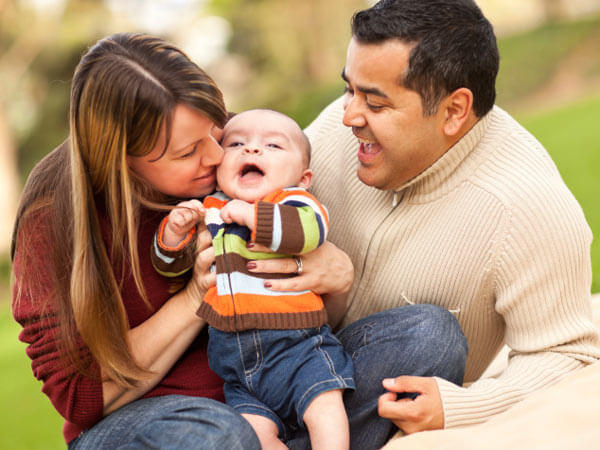 Family with infant child in a park