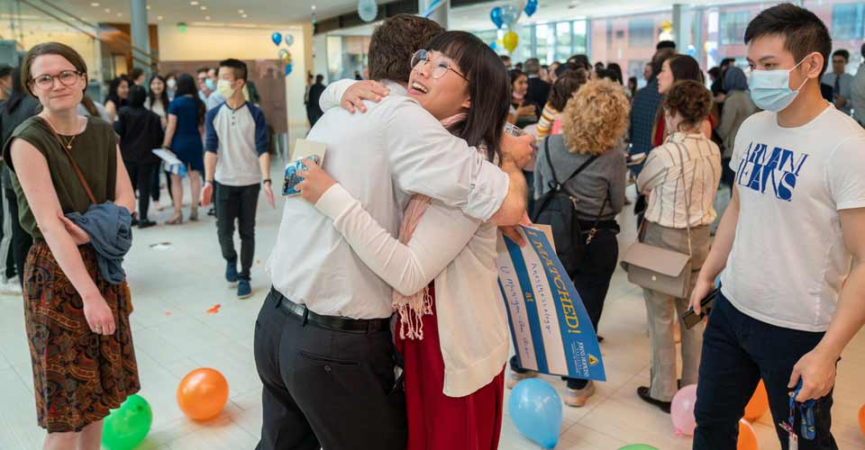 A congratulatory hug is shared as celebrations continue.