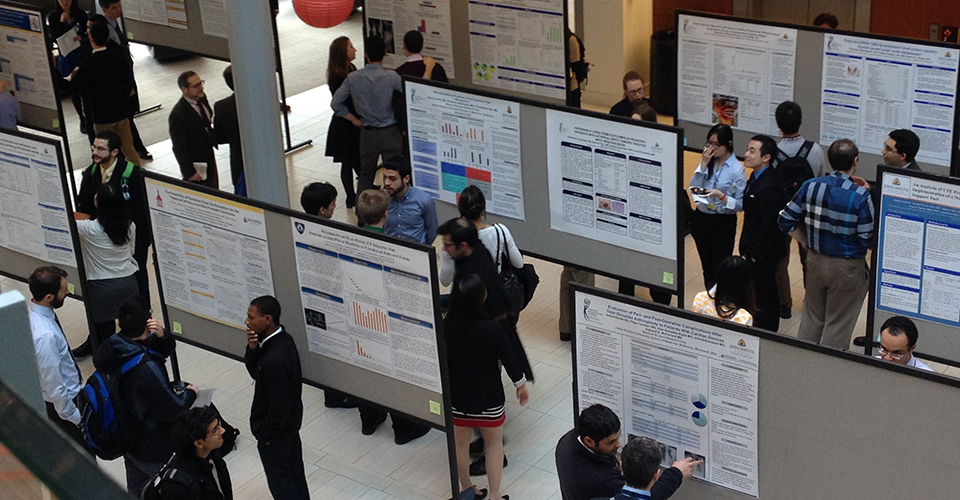Attendees browse research posters.