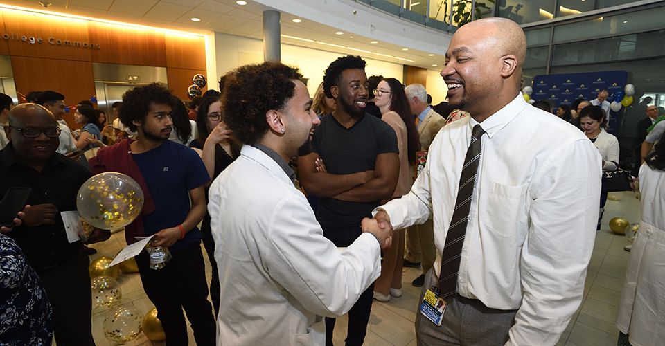 Faculty member congratulating a student on Match Day. 