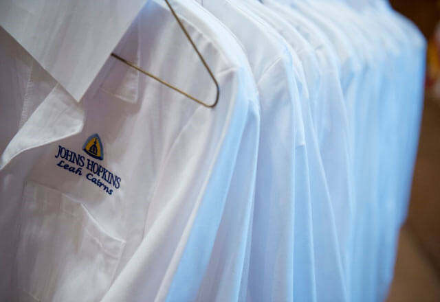White coats hanging on a rack.