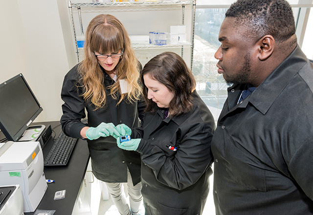 students with slide in the lab