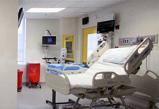 Interior shot of the Biocontainment Unit, showing a hospital bed and a care room.