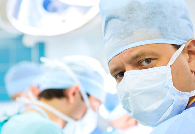 doctors in surgery room wearing masks