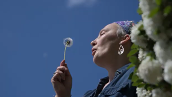 a woman with a dandelion