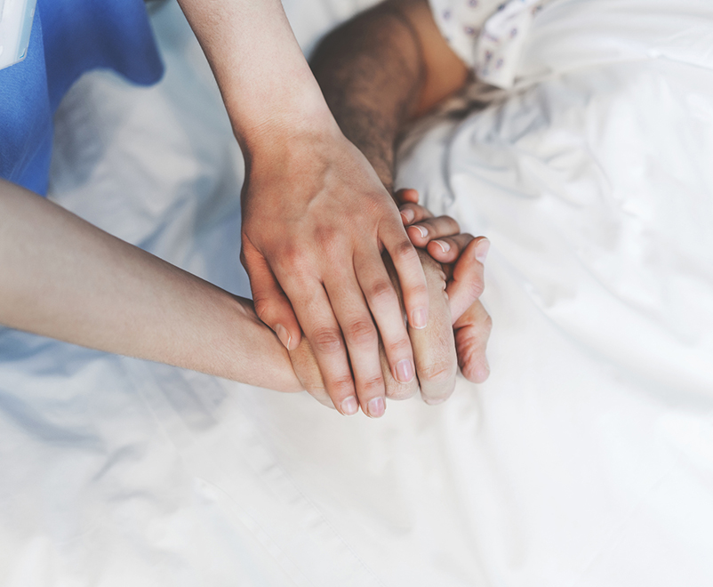 Doctor holding patient's hand