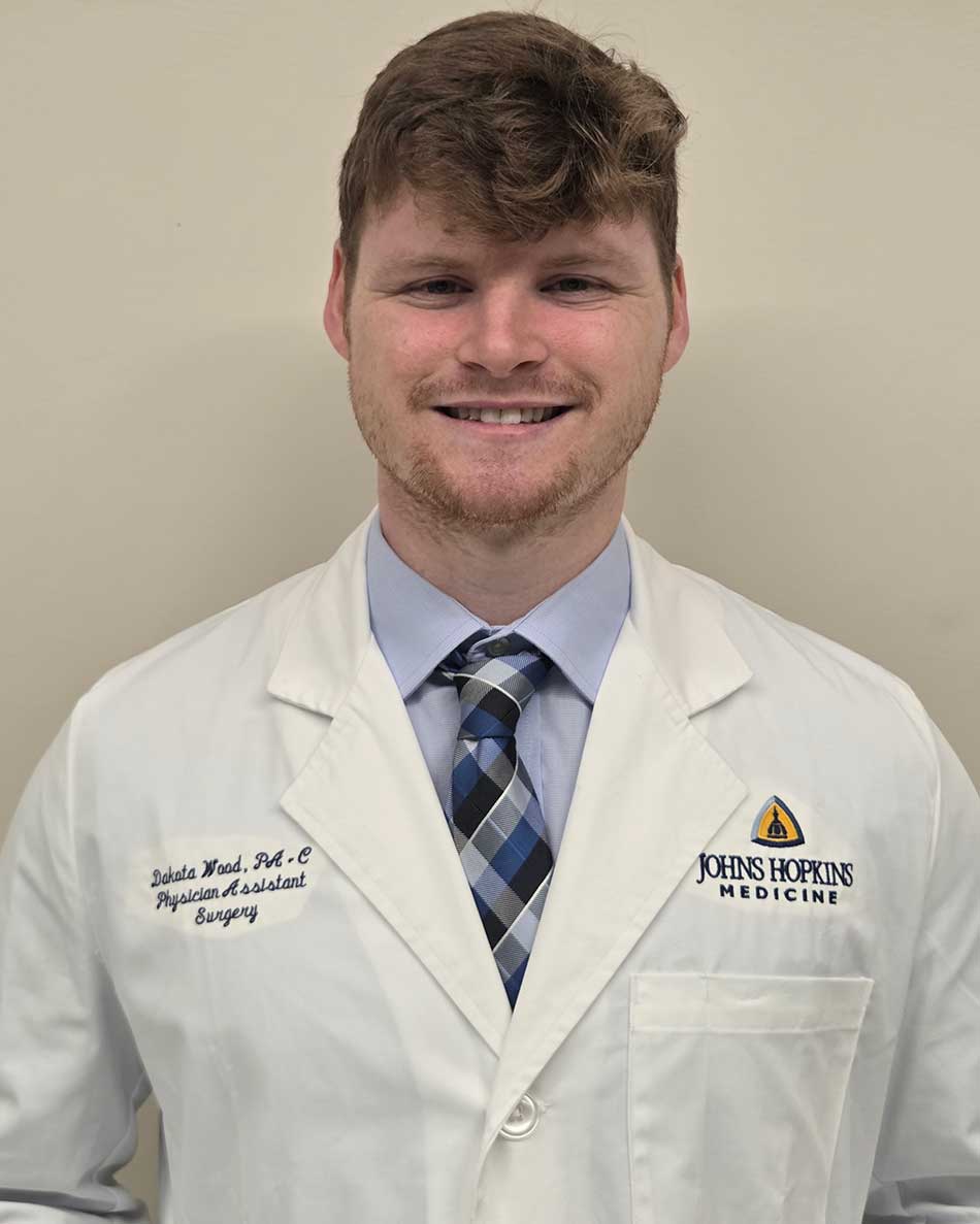 Dakota Wood in a white coat