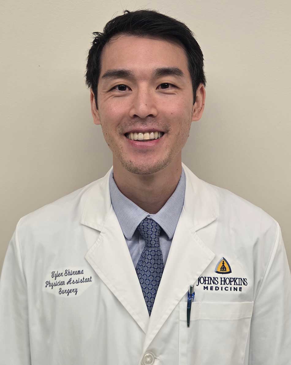 Tyler Shiroma in a white coat