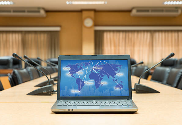 global surgery - image of laptop in middle of conference room