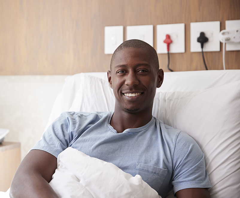 man smiling in hospital bed