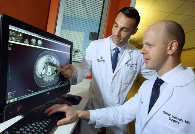 residents examine an x-ray