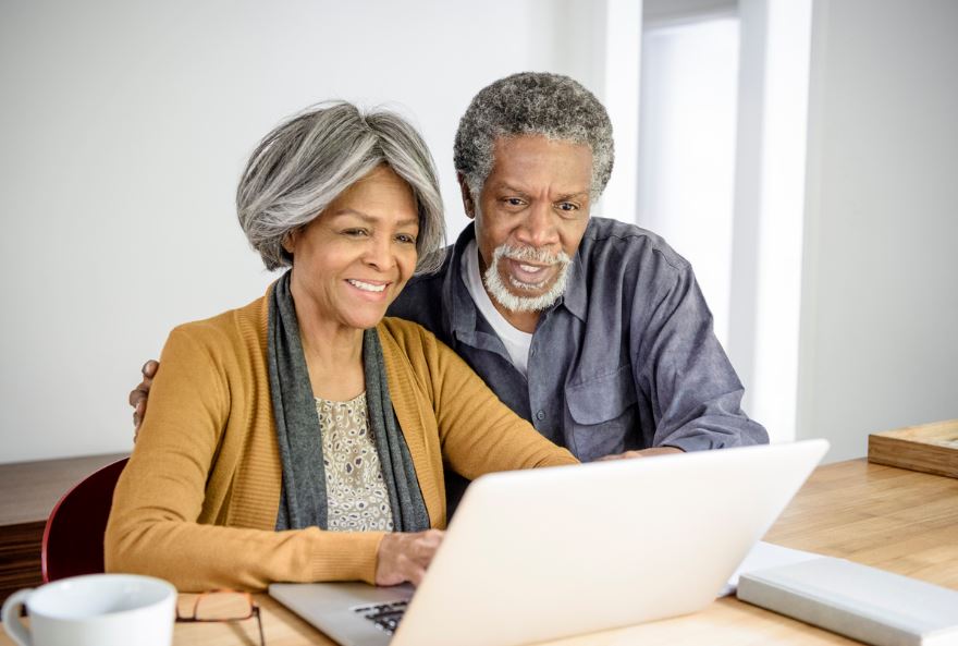An older couple use a computer together