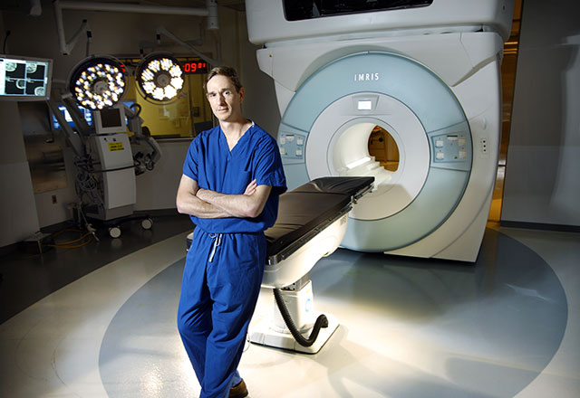 a surgeon in front of the intraoperative MRI machine