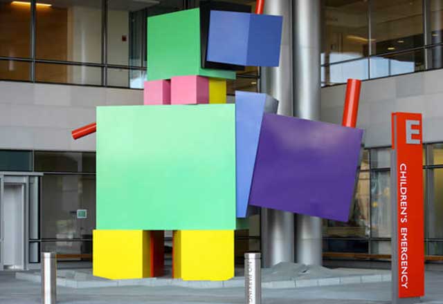 Sculpture of brightly colored blocky rhinos.