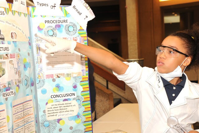 young boy presenting science project
