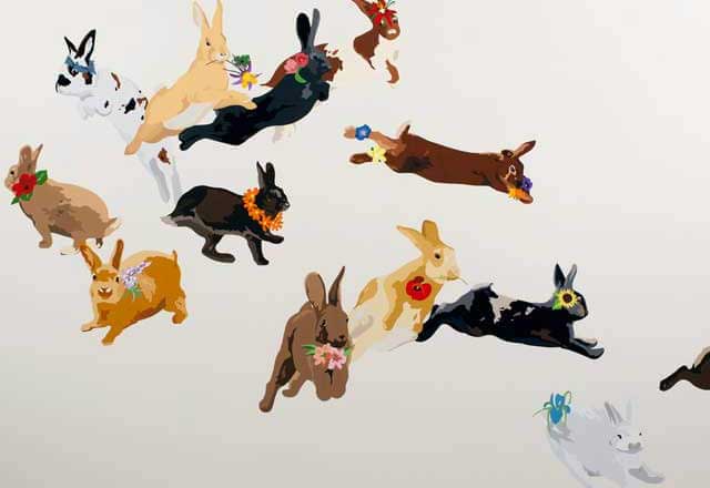 Artwork showing rabbits hopping and carrying flowers in their mouths.