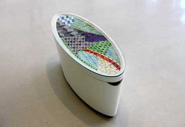 Table Artwork with different colored mosaics on the top.