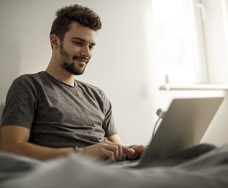 man in bed using laptop - auto islet transplant