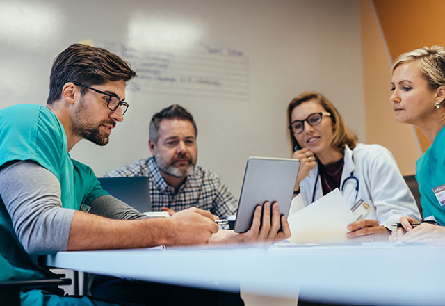 a group of researchers discussing their findings