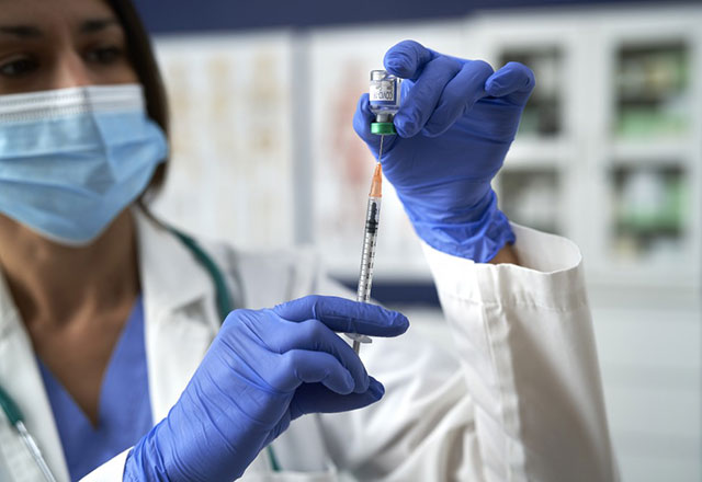 a doctor preparing a vaccine