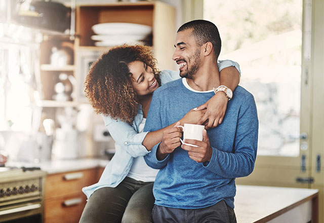 couple smiling in kitchen