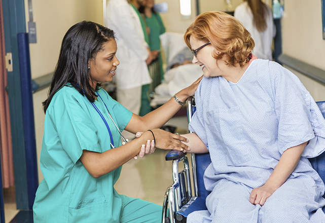 transplant patient information - woman in wheelchair smiling at nurse