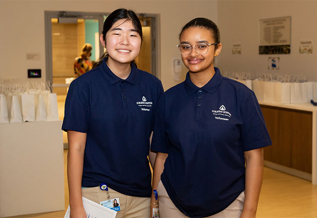Two young volunteers posing for a picture.