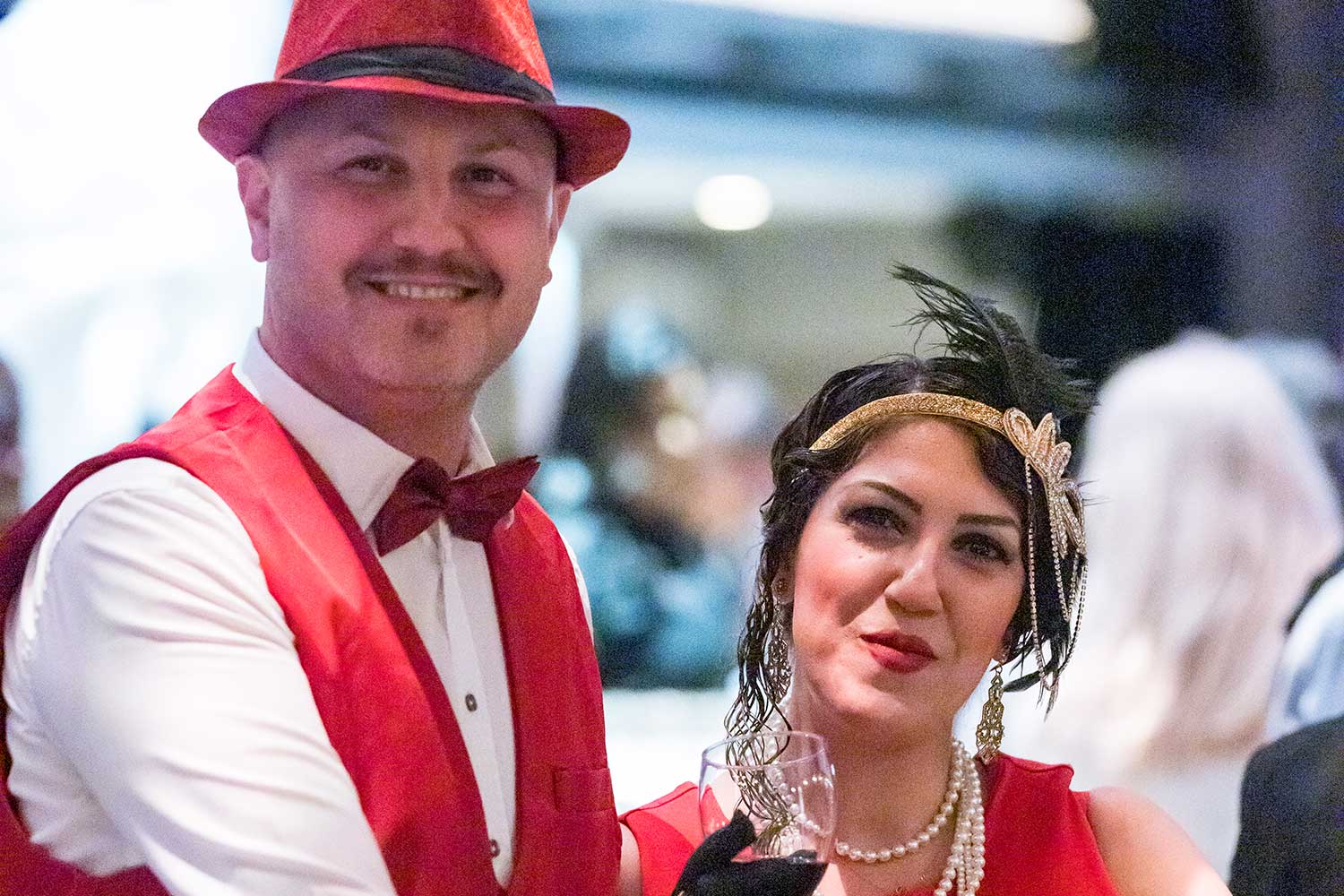 Couple wearing red 20s attire