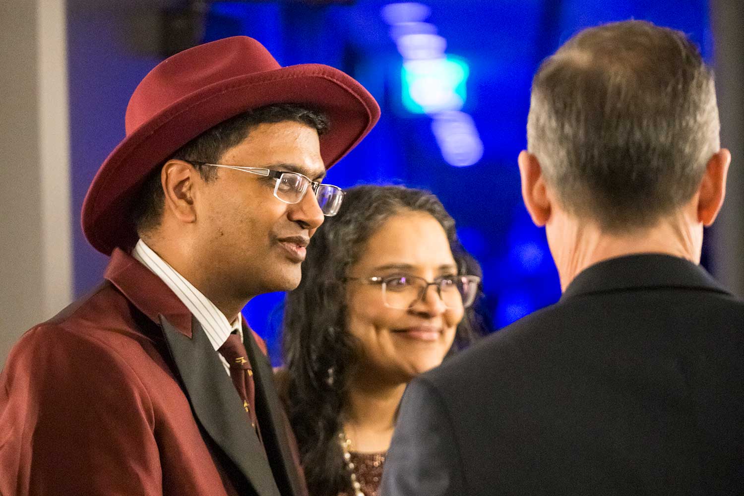 Three attendees speaking in a small group