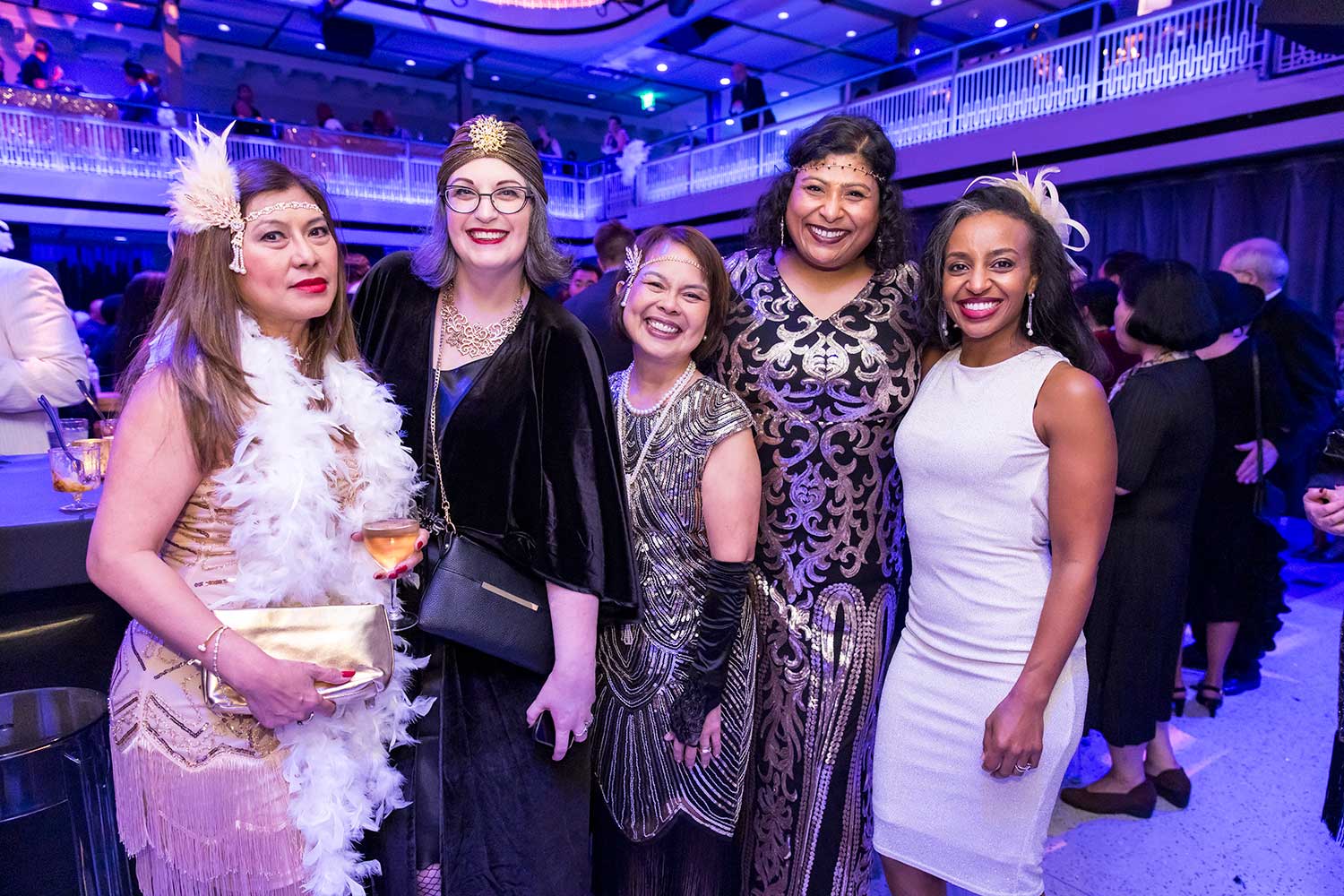Group of five women in 20s attire and accessories