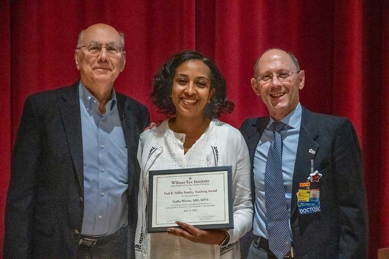 Neil Miller, Fasika Woreta, Henry Jampel smiling with an award