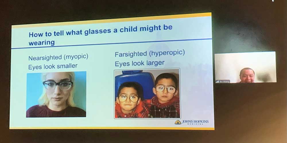 Bo Wang presenting a slide titled how to tell what glasses a child might be wearing