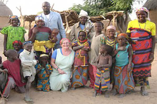 Dr. Sheila West in Africa with local residents