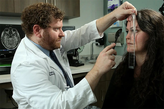 Dr. Colin Kane with a patient during an exam.