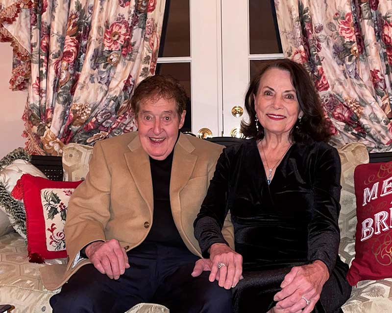 William and Patricia Bright smile together in a living room