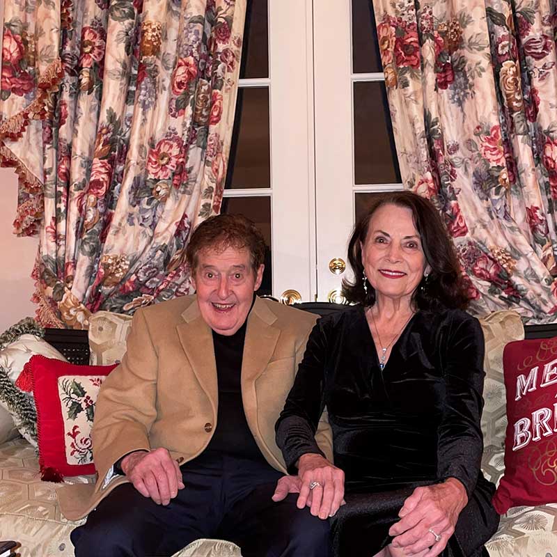 William and Patricia Bright smile together in a living room