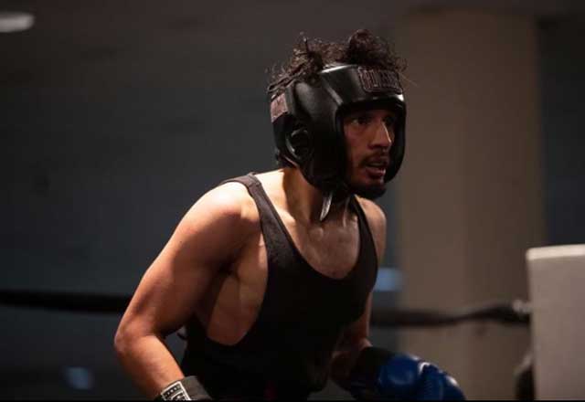 John in boxing gear during a match