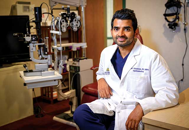 Jithin Yohannan wearing a white coat in the lab
