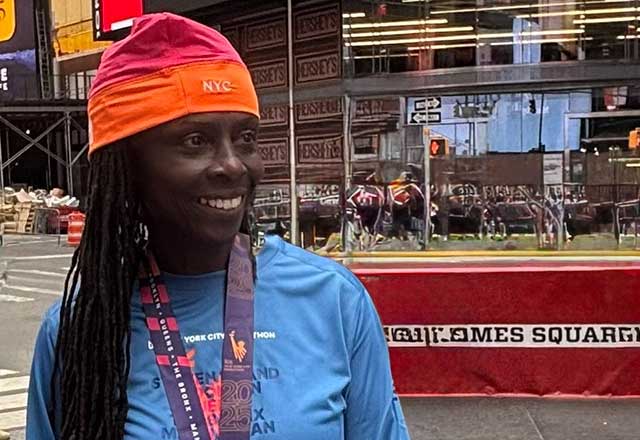 Jackie King smiling while wearing her marathon medal