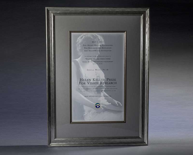 A framed plaque with a portrait of Helen Keller that reads Helen Keller Prize for Vision Research
