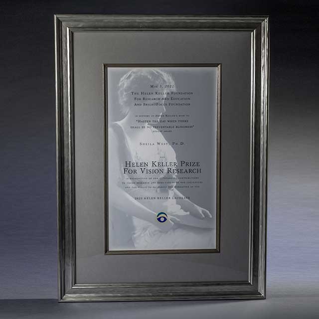 A framed plaque with a portrait of Helen Keller that reads Helen Keller Prize for Vision Research