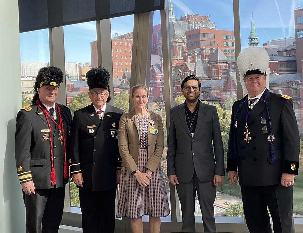 Doctor Kraus and researcher Abhishek posing together with three members of the Knights Templar