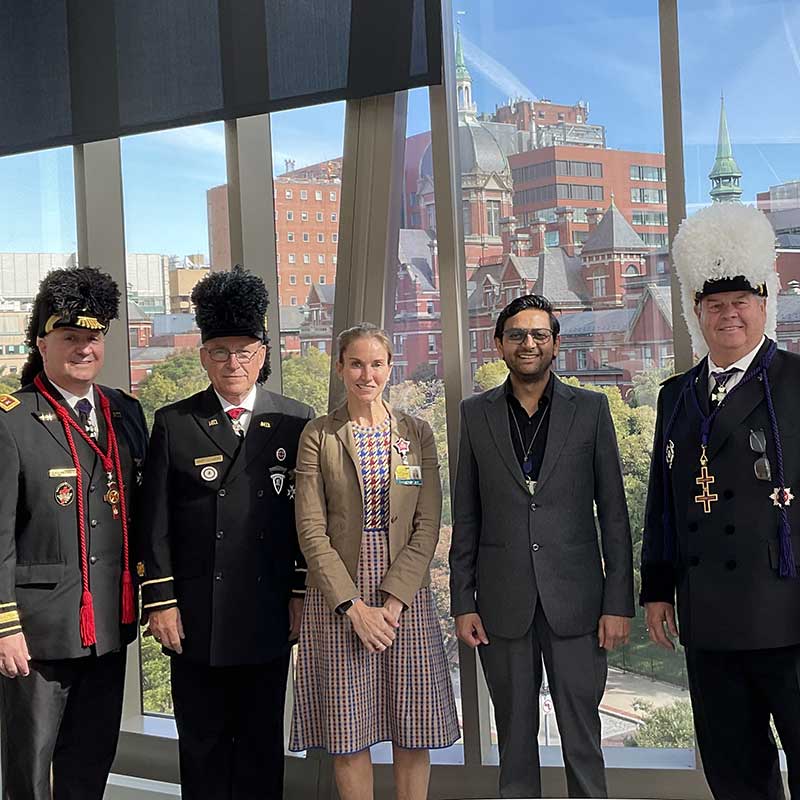 Doctor Kraus and researcher Abhishek posing together with three members of the Knights Templar