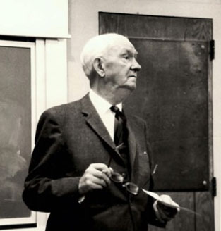 Black and white photo of Dr. Walsch hosting a Saturday morning conference